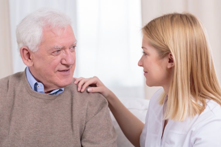 A woman conversing with an elderly man.